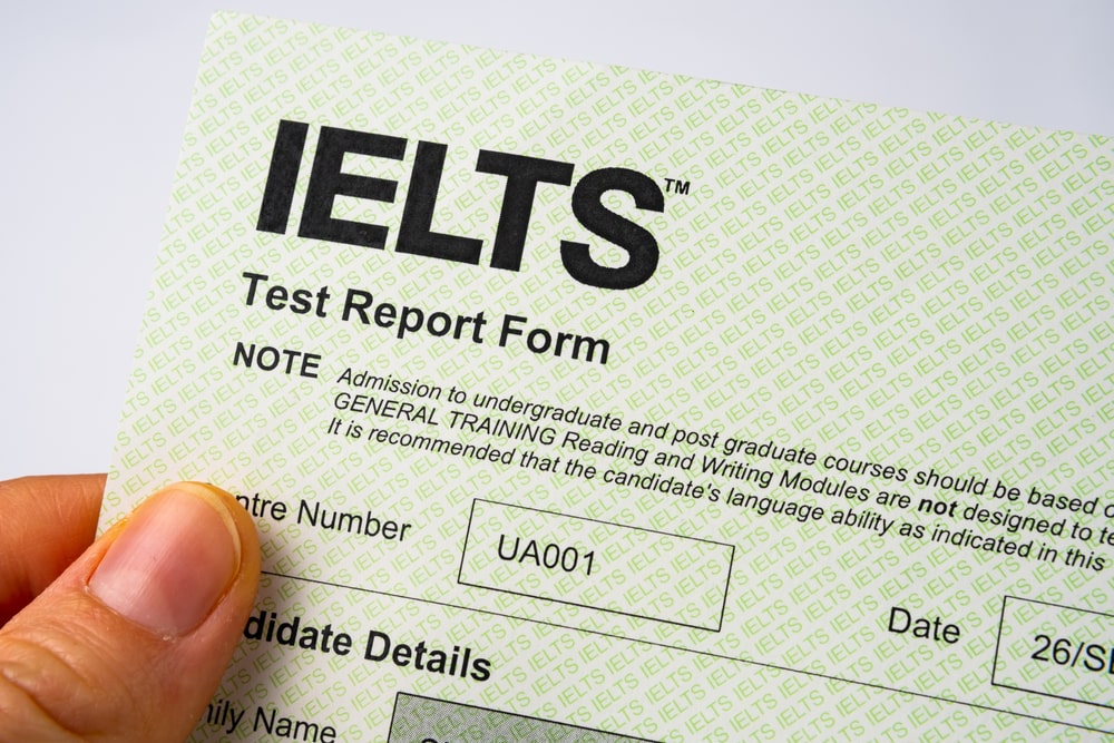 A person holding IELTS test form
